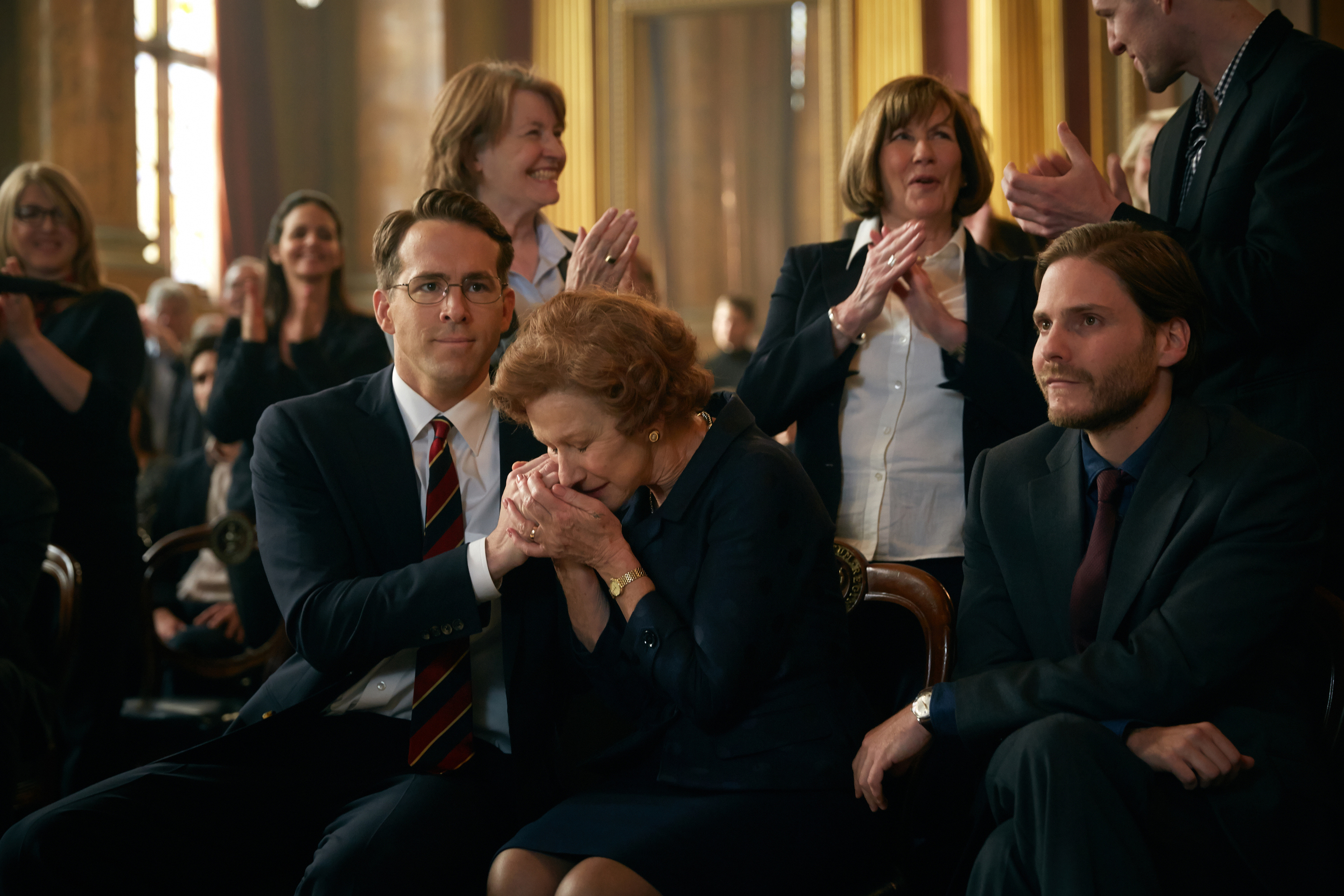 (L-r) Ryan Reynolds, Helen Mirren, and Daniel Bruhl star in The Weinstein Company's "Woman in Gold"