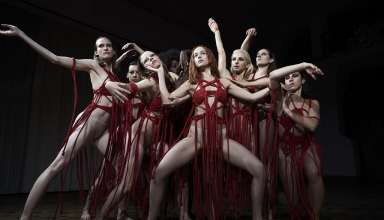 Dakota Johnson (center) and Mia Goth (center-left) star in Amazon Studios' SUSPIRIA